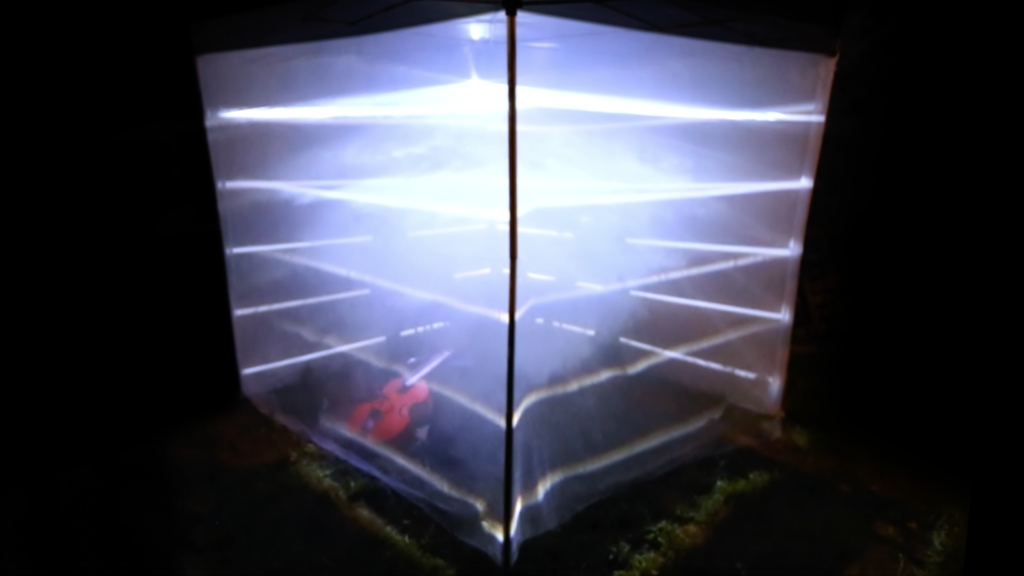 Cubo translúcido iluminado desde dentro con líneas de luz, en la oscuridad.